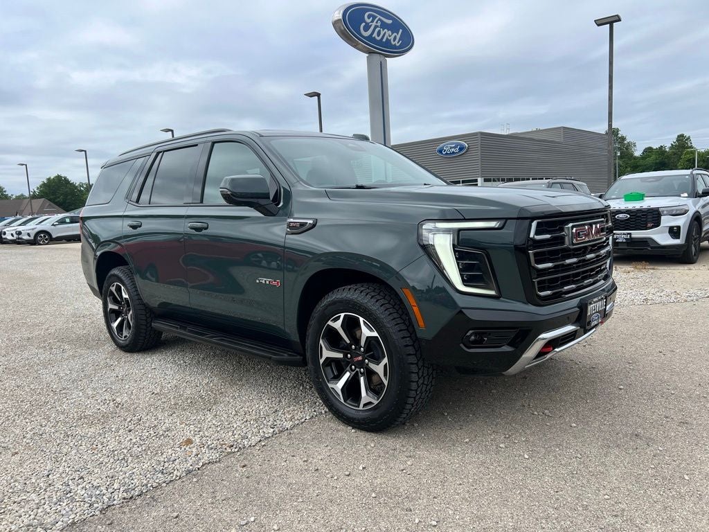 2025 GMC Yukon AT4 in Midnight Pine — front three-quarter view